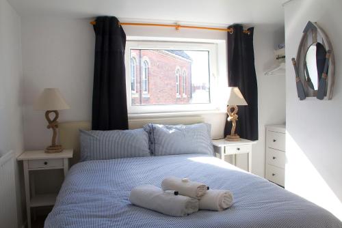 a bed with a stuffed animal on top of it at Timrick Lodge in Weymouth