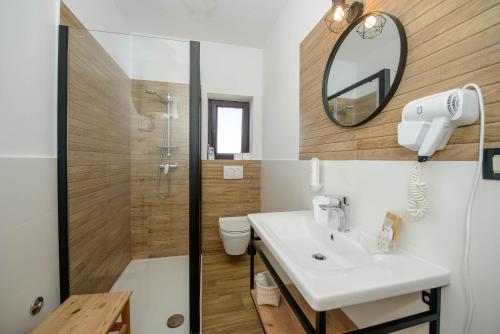 a bathroom with a sink and a shower and a toilet at Guests house DaLi in Rovinj