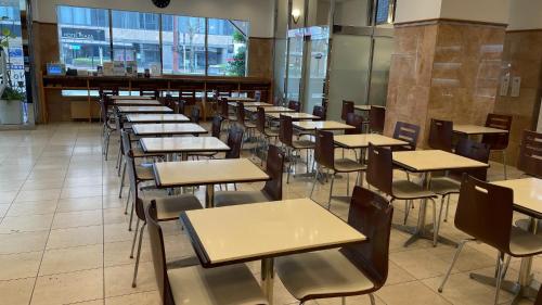 a row of tables and chairs in a cafeteria at Toyoko Inn Kagoshima Temmonkan No 2 in Kagoshima