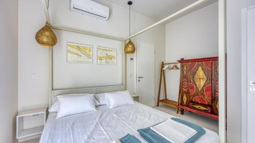 a bedroom with a white bed and a red cabinet at Villa Menta 4 by Villas Guide in Malinska