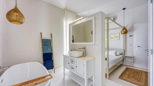 a white bathroom with a sink and a mirror at Villa Menta 4 by Villas Guide in Malinska