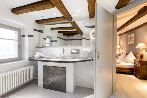 a bathroom with a sink and a fireplace at Eventlocation & Hotel Schloss Neuburg in Obrigheim