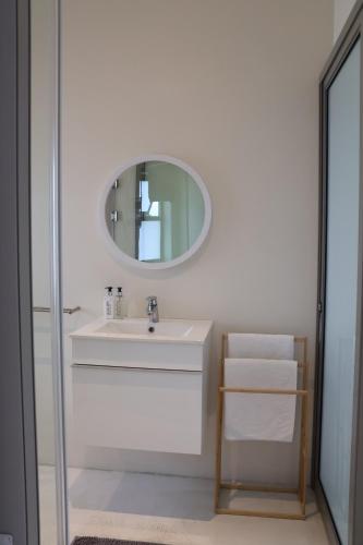 a bathroom with a sink and a mirror at Sarah's Place -Stilbaai in Stilbaai