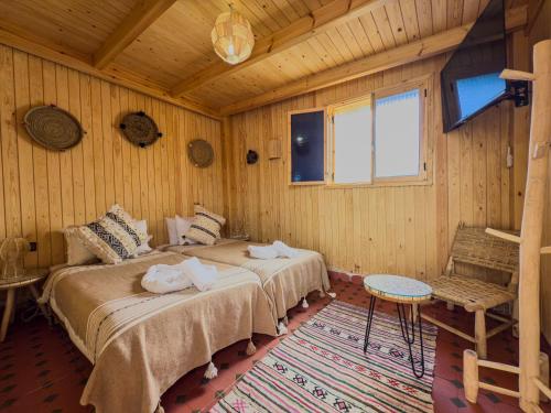 a bedroom with two beds with towels on them at RIAD AMR in Tangier