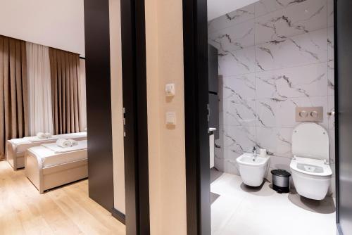 a bathroom with a toilet and a sink at 7 Star Apartments in Tashkent