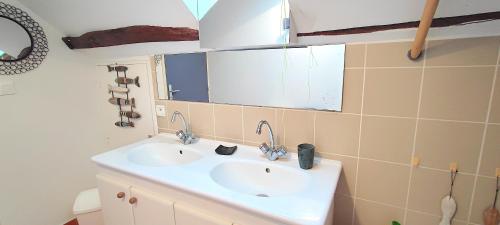 a bathroom with a sink and a mirror at La Mondee in Badefols-dʼAns