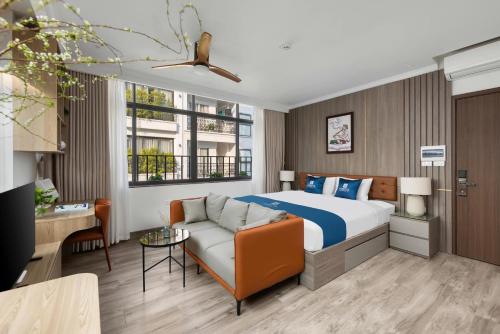a hotel room with a bed and a couch at 3A Hometel Hanoi in Hanoi