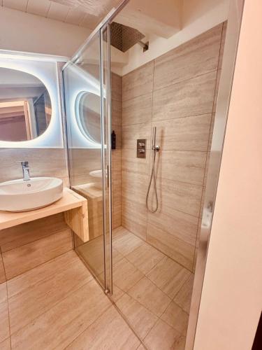 a bathroom with a shower and a sink at B&B Morbegno in Morbegno