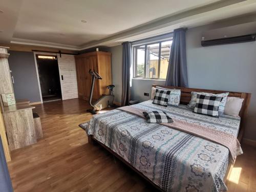 a bedroom with a bed and a large window at The Serenity in Mauritius