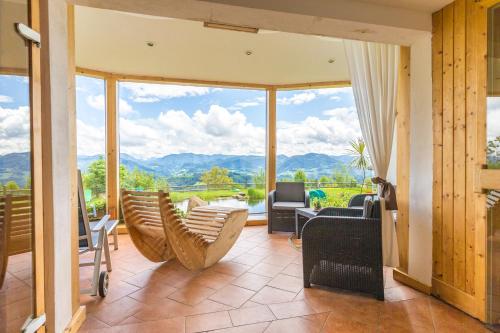 a living room filled with furniture and a large window at Biohof Ebenbauer in Waidhofen an der Ybbs