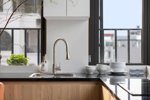 a kitchen with a sink and two bowls on a counter at 3A Hometel Hanoi in Hanoi
