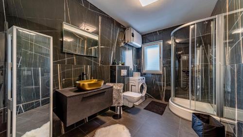 a bathroom with a sink and a tub and a toilet at Villa Franka by Villas Guide in Vela Luka