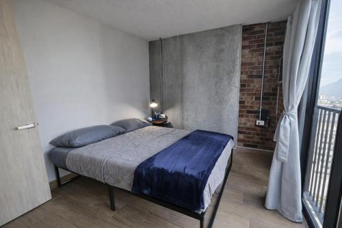 a bedroom with a bed and a large window at BarrioW Apartment 1 Room, parking, pool and view in Monterrey
