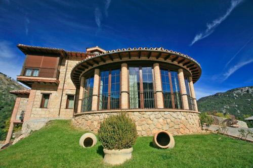 a large stone house on top of a hill at Coto del Valle de Cazorla in Cazorla