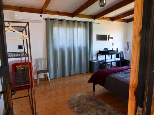 a bedroom with a bed and a desk in a room at Black Sunbird Retreat in Heidelberg