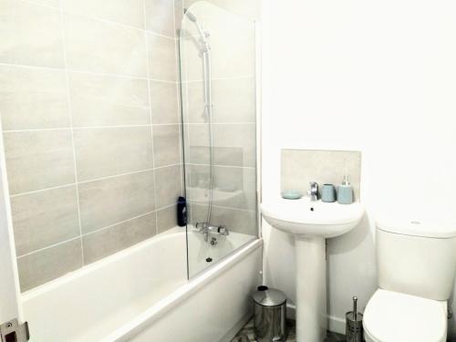 a bathroom with a sink and a toilet and a shower at Sigma Executive Apartment 5 in South Shields