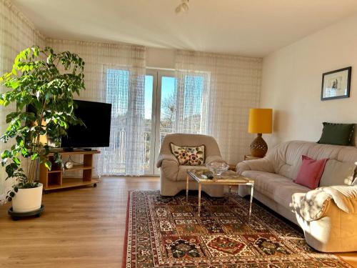 a living room with a couch and a tv at Ferienwohnung Bärbel in Freyung