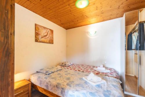 a bedroom with a bed and a wooden ceiling at Casa Sybille, beautiful lake view in Minusio