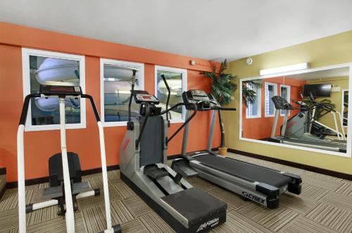 a gym with two tread machines and two mirrors at Travelodge by Wyndham Lloydminster in Lloydminster