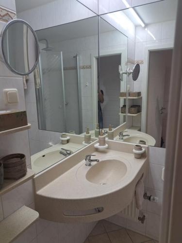a white bathroom with a sink and a mirror at Sternenacht in Sankt Englmar