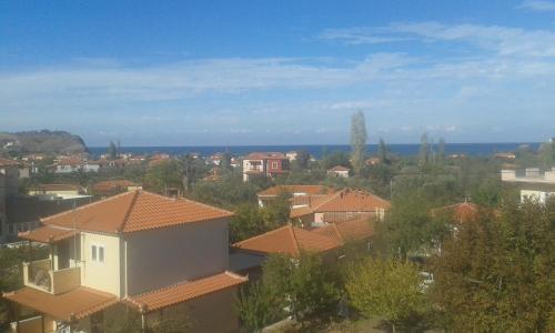 a view of a town with houses and the ocean at Vassilis Studios in Anaxos