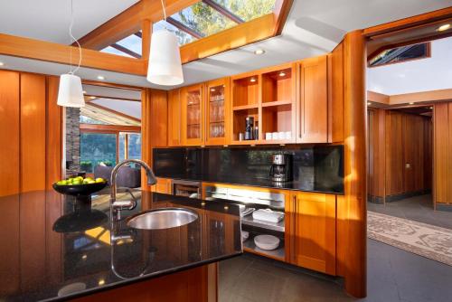 a kitchen with wooden cabinets and a sink at Chuckanut Point Villa 2 Bedroom in Bellingham