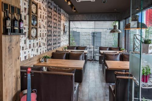 a dining room with wooden tables and leather chairs at Hotel Idol in Targovishte