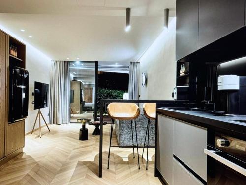 a kitchen with a counter and some chairs in it at Comfort and Relaxation in Athens
