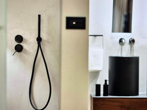 a shower head hanging on a wall in a bathroom at Comfort and Relaxation in Athens