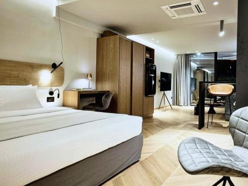 a hotel room with a bed and a living room at Comfort and Relaxation in Athens