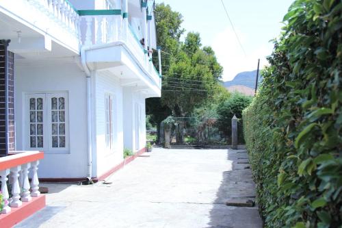 an empty street next to a white building at Blue Moon Hotel in Nuwara Eliya