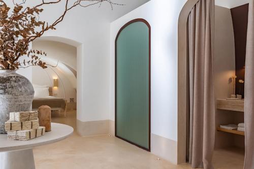 a room with a mirror and a table with a vase at Masseria Valentina in Ostuni
