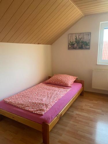 a bedroom with a bed with a purple mattress at Rekreační dům Strachotín in Strachotín