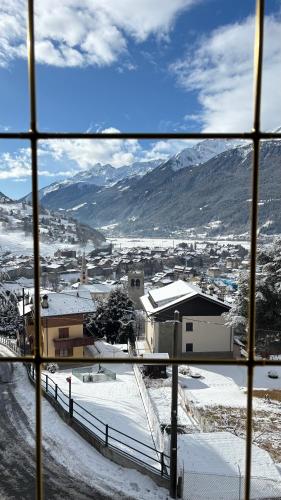 a view from a window of a town in the snow at Appartamento Panorama Bormio in Bormio