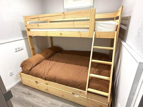a bunk bed in a small room with a ladder at Loft 4 personas en La Molina in La Molina