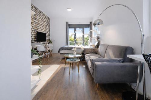 a living room with a couch and a table at Eco Smart Apartments Erlangen in Erlangen