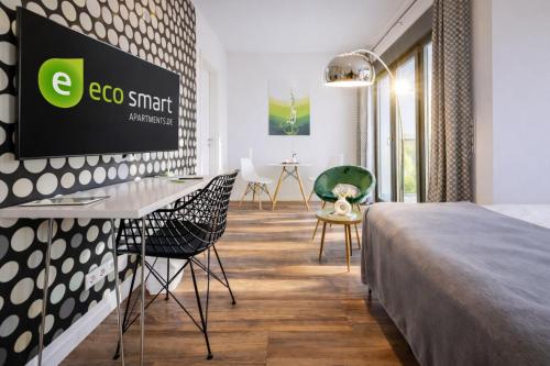 a hotel room with a bed and chairs at Eco Smart Apartments Erlangen in Erlangen