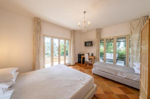 a bedroom with two beds and a table at Villa Carlotta Resort in San Leone