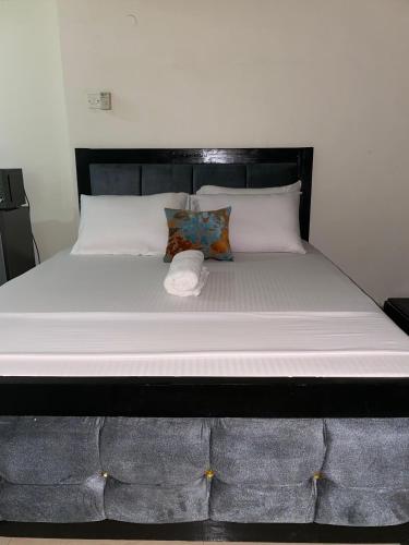 a bed with a white mattress and a pillow at Bliss Residence Studio Mtwapa in Mtwapa
