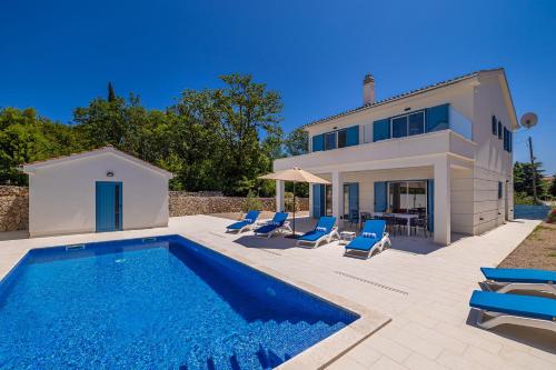 a villa with a swimming pool and a house at Holiday house DAN with private pool in Kras