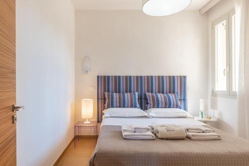 a bedroom with a large bed with towels on it at Agriturismo Residenza Gemma in Porto Cesareo