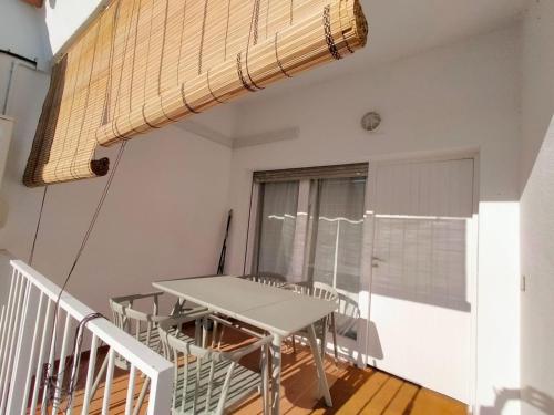 a balcony with a table and chairs in a room at Apartaments Aeroclub in Empuriabrava