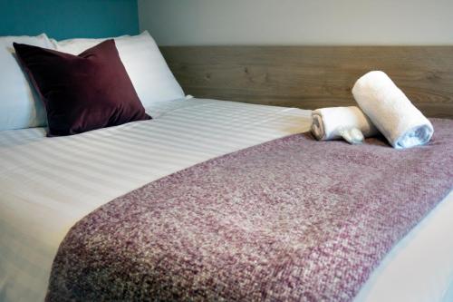 a bed with two pillows on top of it at Queen Street Place in Galway