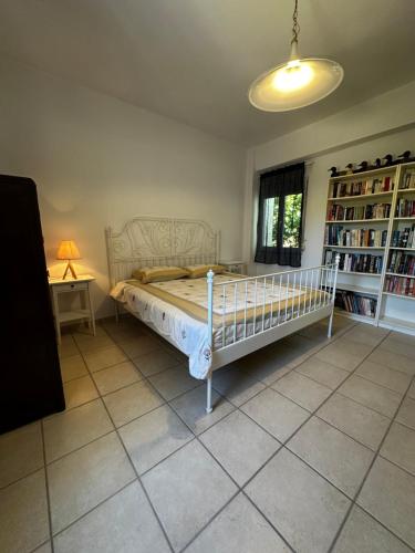 a bedroom with a bed and a book shelf at Ellie's Kantanos in Kántanos