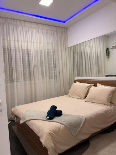 a bedroom with a large bed with a blue ceiling at Elégance & Confort in Rabat