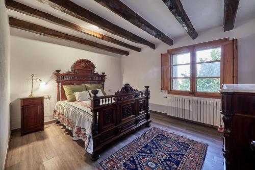 a bedroom with a large bed and a window at LuxRural Montserrat | Piscina con Vistas Únicas in Marganell