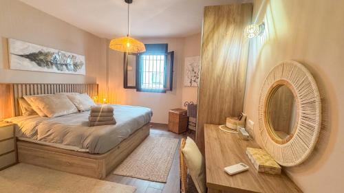 a bedroom with a large bed and a fan at Las Huertas 12 in Frigiliana