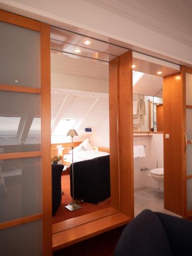 a view of a bedroom through a glass door at Hanseat in Helgoland