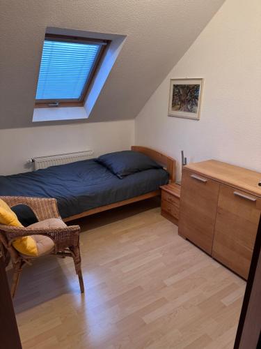 a bedroom with a bed and a window at Apel Apartments 2 in Nörten-Hardenberg