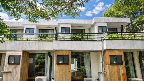 an exterior view of a house with a balcony at Minami Hakone Villa in Kannami